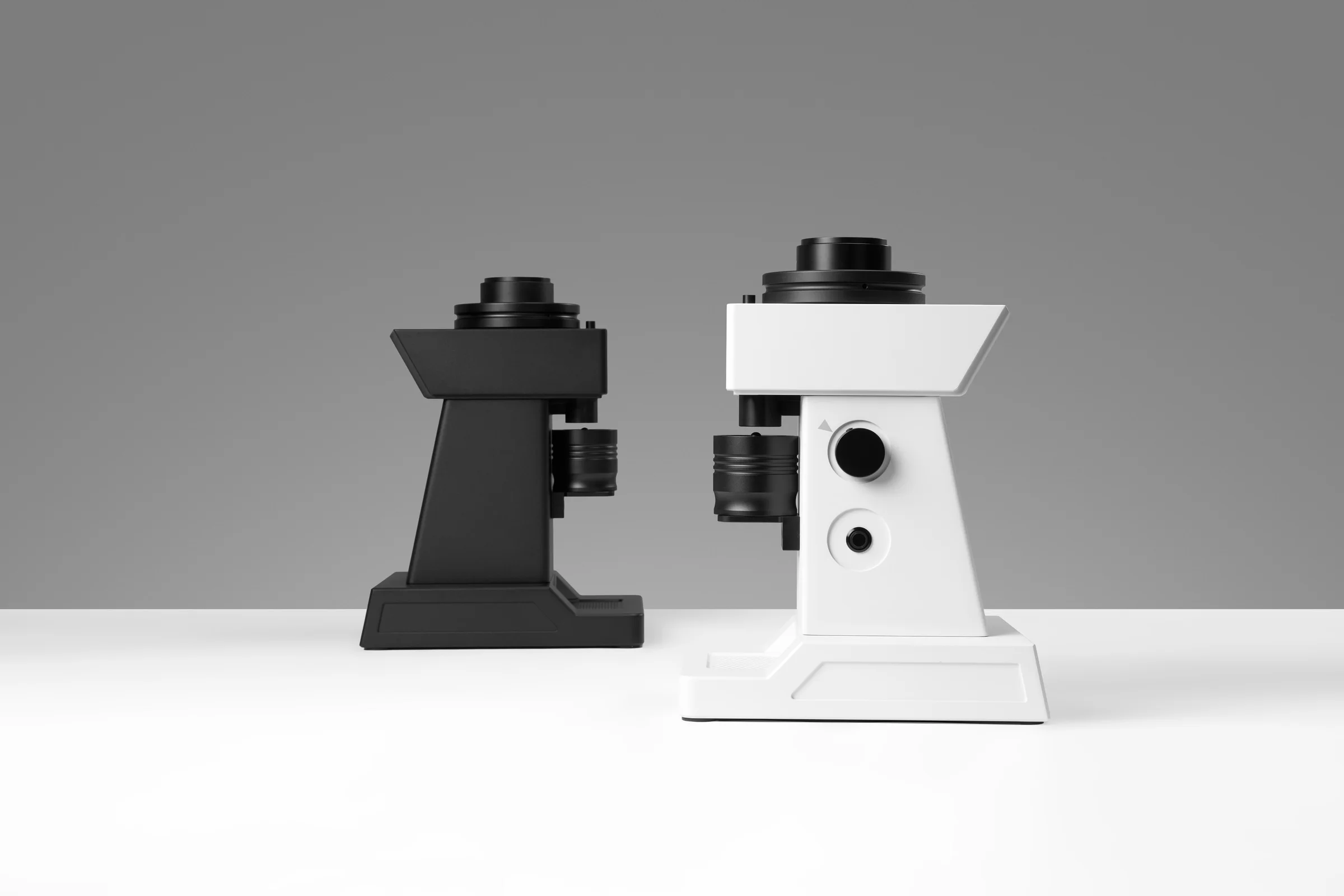 Black and white YODA conical-burr grinders photographed together in the studio